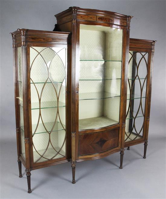 An Edwardian Sheraton Revival inlaid mahogany serpentine display cabinet, W.5ft 10in. D.1ft 8in. H.6ft 1in.